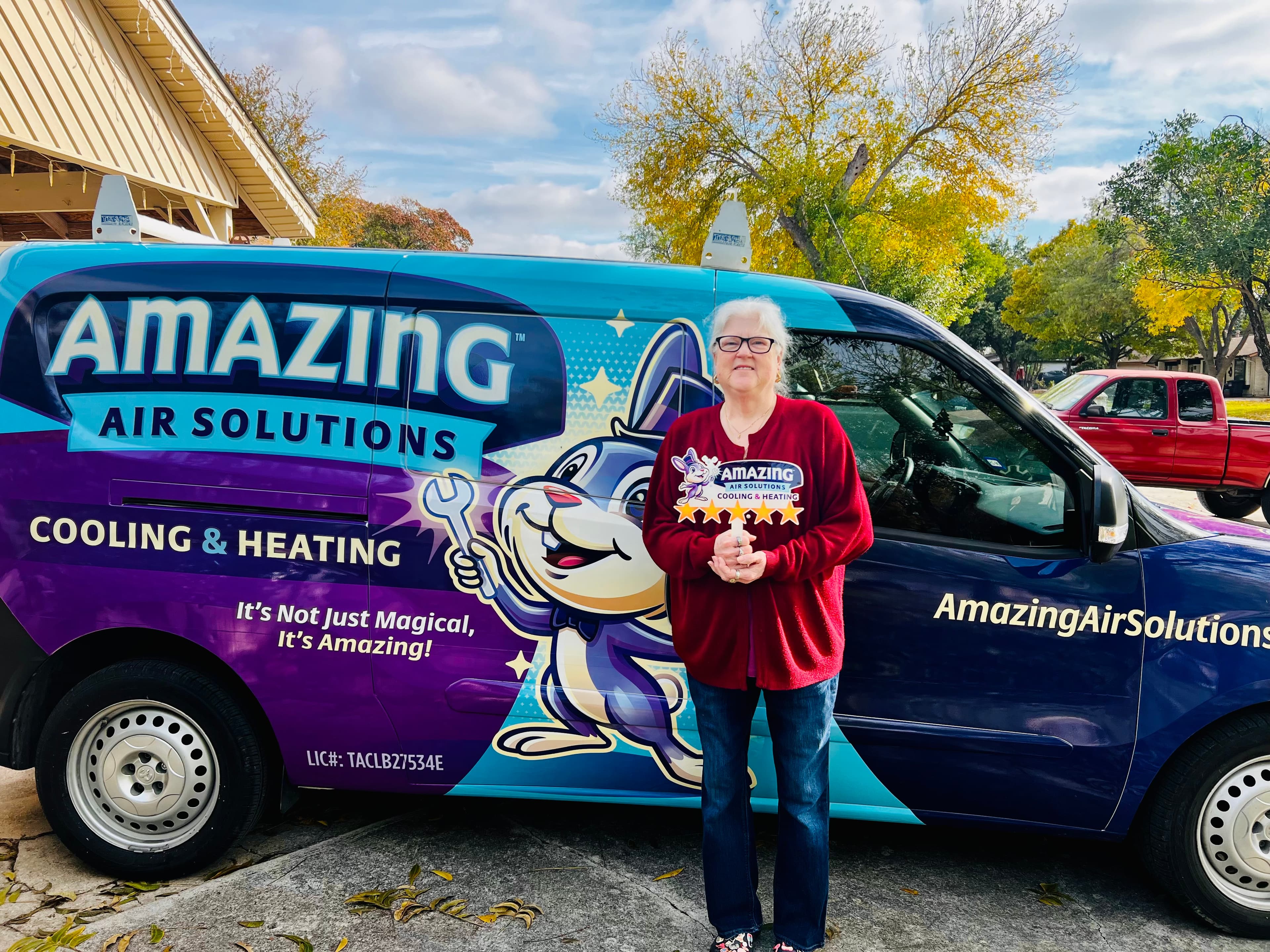 Roy Jaramillo with a customer beside the Amazing Air Solutions service van